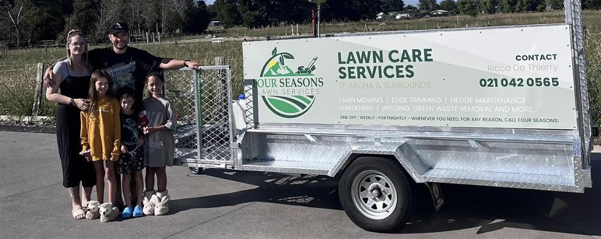 Ricco and family from Four Seasons Lawn Services with their lawn care trailer